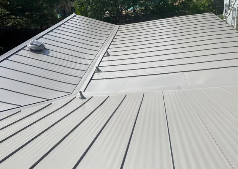 Solar attic fan installed on a metal roof for Roof Ventilation in Holiday